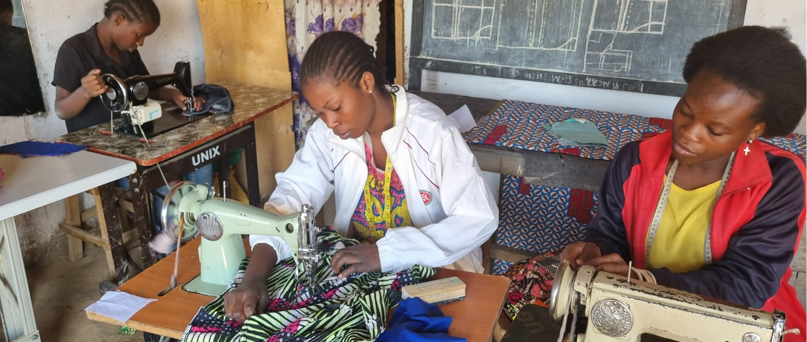 Teen mothers participating in tailoring training with YAREN