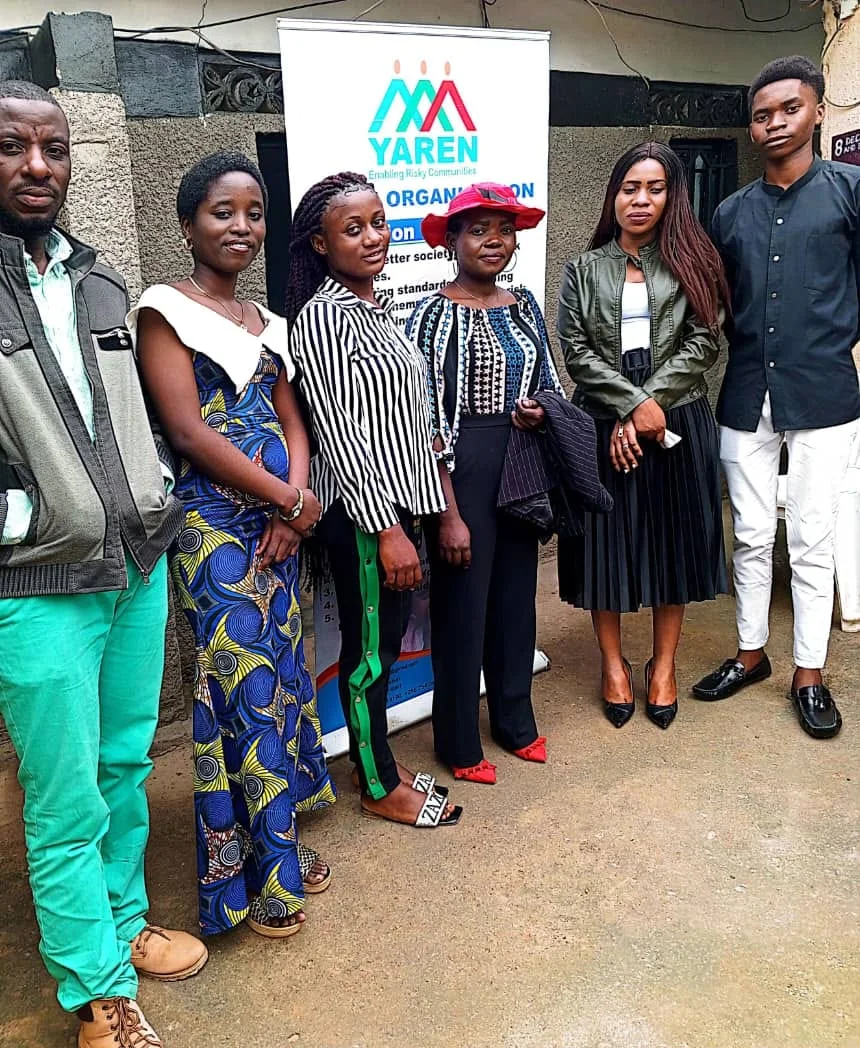 Six members of the YAREN team standing in front of the YAREN Organisation banner