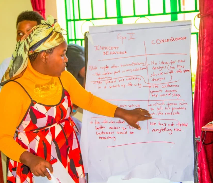 A participant presenting a group's ideas on a flip chart