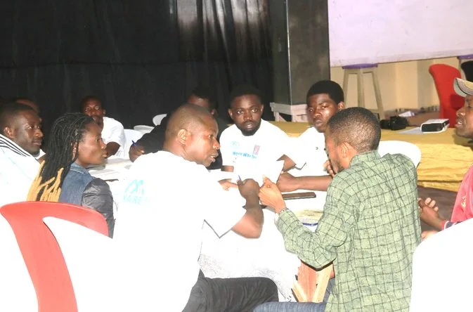 A discussion group seated around a table, working through their findings