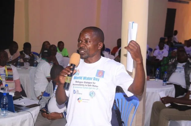 A participant asking the panel a question with a microphone